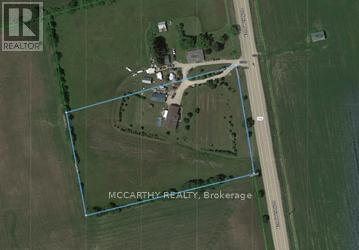 An aerial view of a property with a road and a building.