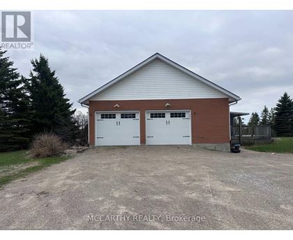 A two-car garage with a brick exterior and a white roof.