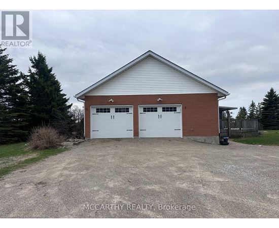 A two-car garage with a brick exterior and a white roof.
