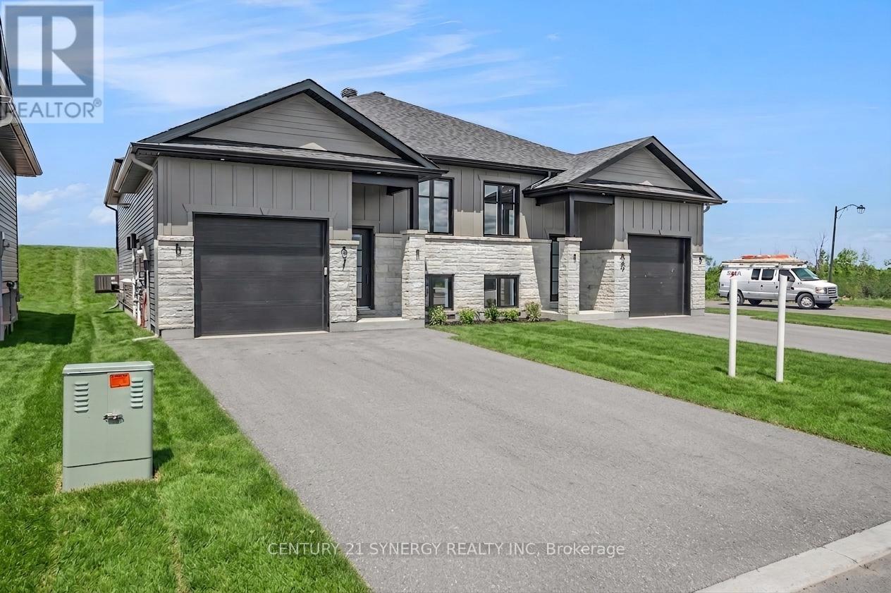 A modern house with a grey roof and a garage door is for sale.