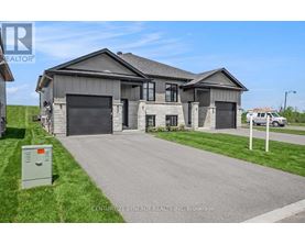 A modern house with a grey roof and a garage door is for sale.