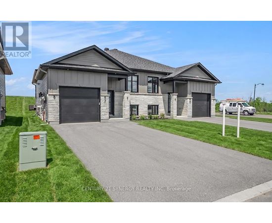 A modern house with a grey roof and a garage door is for sale.