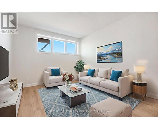 A living room with a white couch, a coffee table, and a painting on the wall.