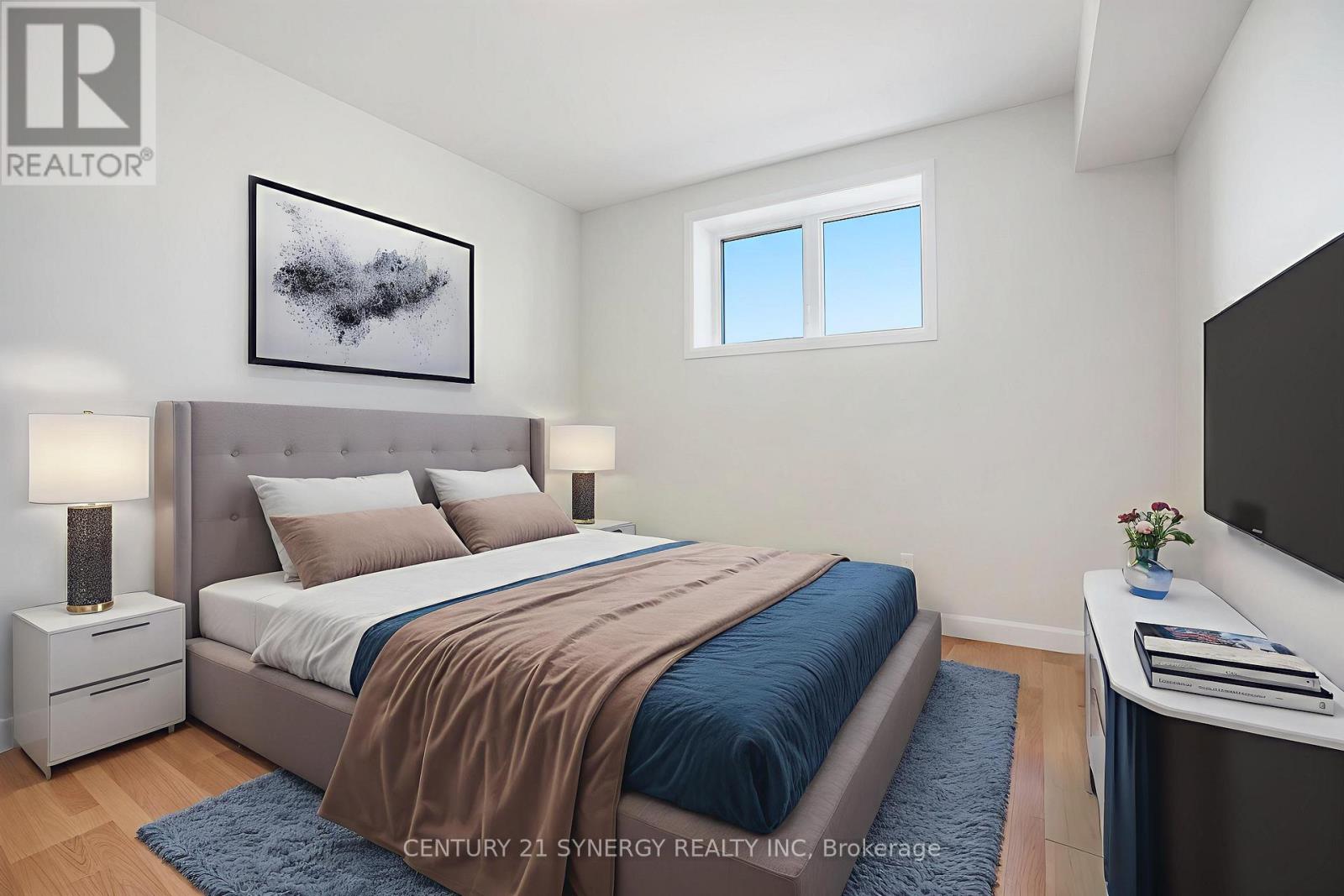 A bedroom with a large bed and a painting on the wall.