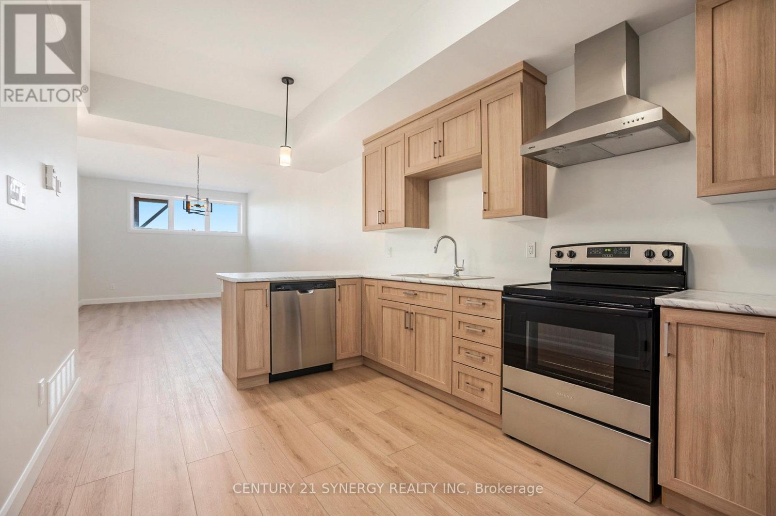 A kitchen with wooden cabinets and stainless steel appliances.