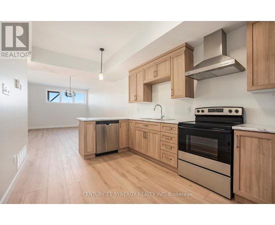 A kitchen with wooden cabinets and stainless steel appliances.