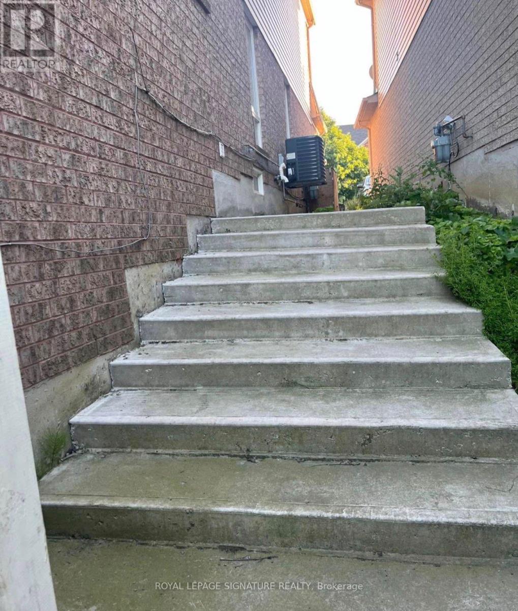 A set of concrete stairs leads up to a building.