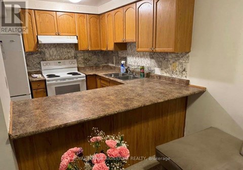 A kitchen with wooden cabinets and a granite countertop.