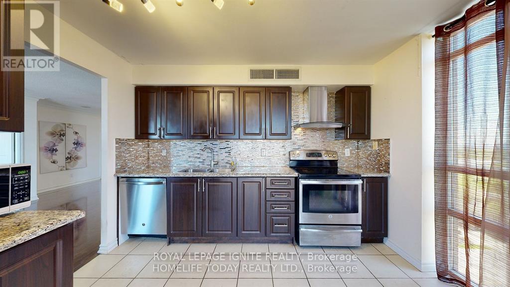 A kitchen with brown cabinets and a granite countertop.