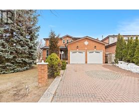 A house with a brick driveway and a snow-covered ground.