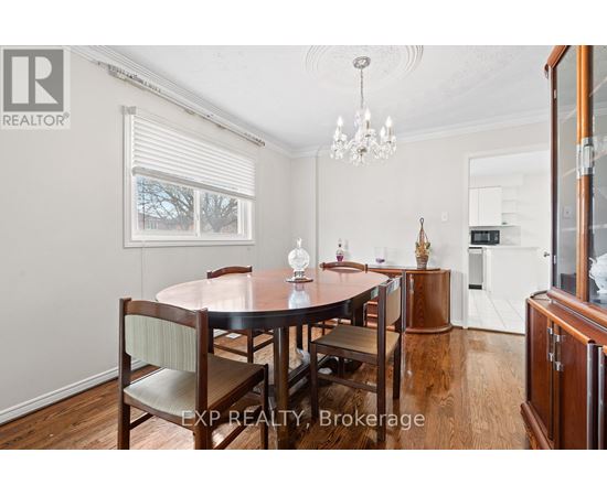 A dining room with a wooden table and chairs.