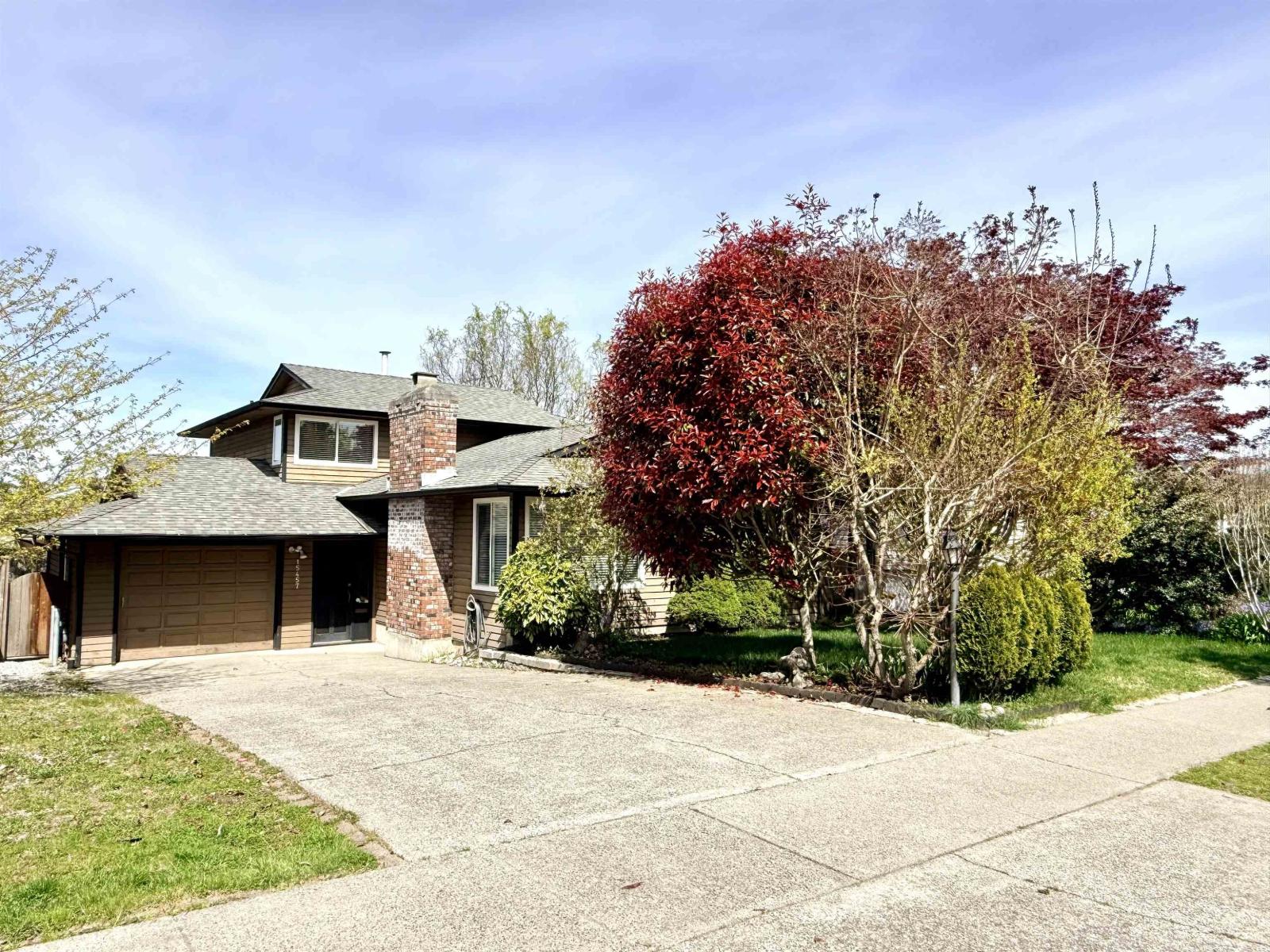 A house with a garage and a driveway.