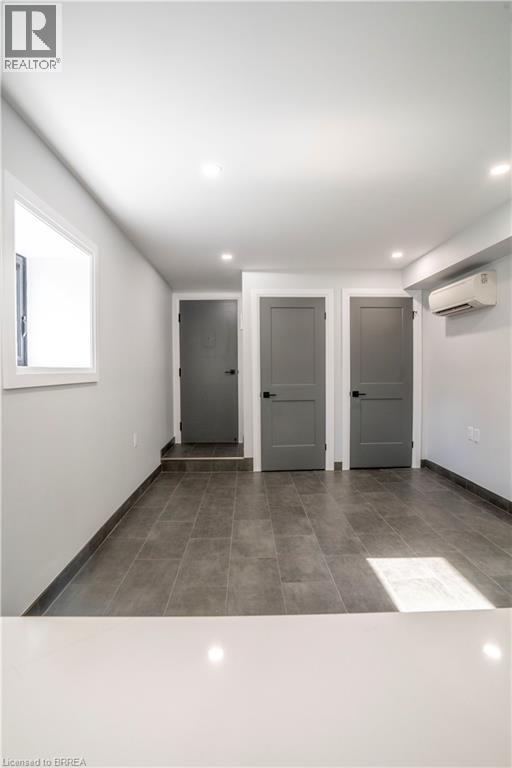 A hallway with two doors and a window.