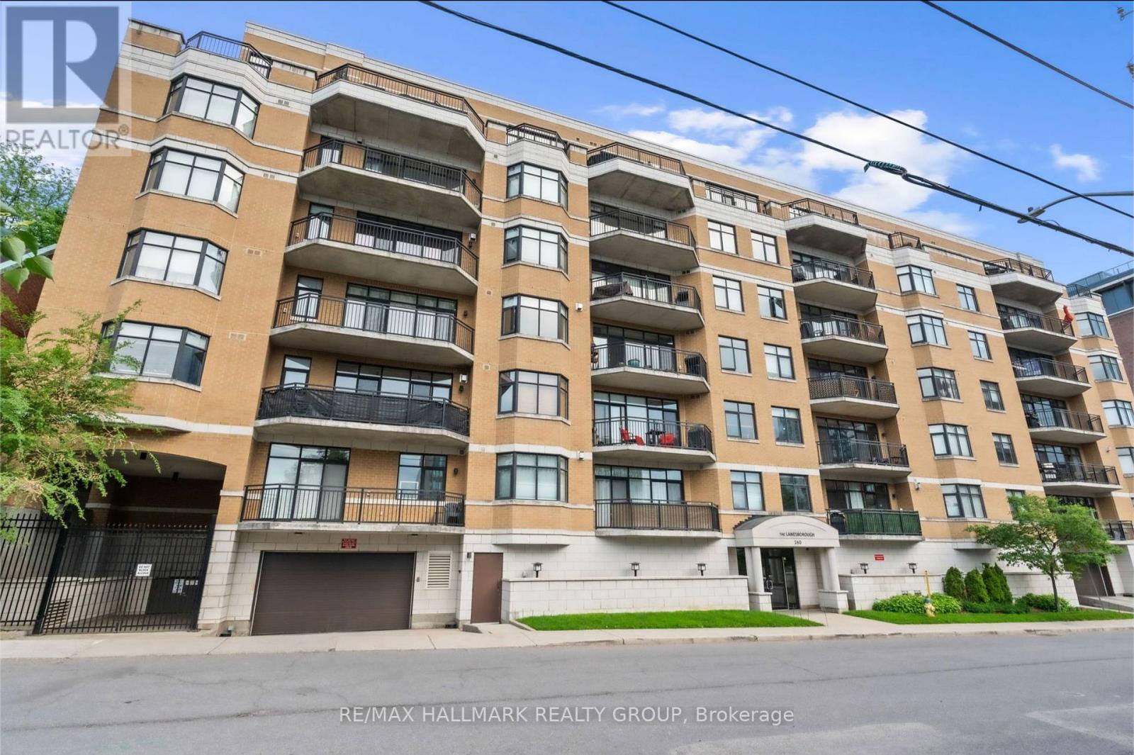 A large apartment building with multiple balconies and doors.