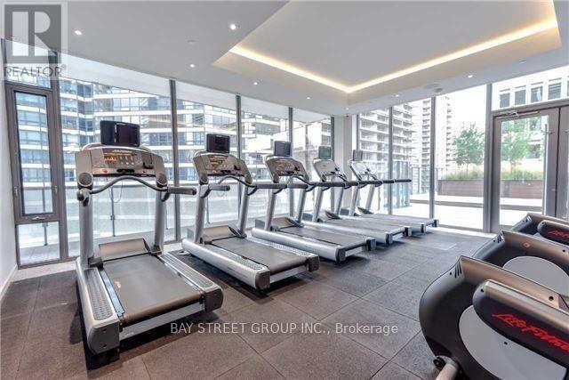 A gym with treadmills and a view of the city.