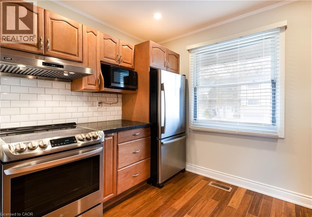 A kitchen with wooden cabinets and stainless steel appliances.