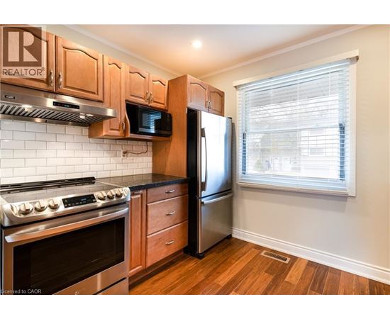 A kitchen with wooden cabinets and stainless steel appliances.