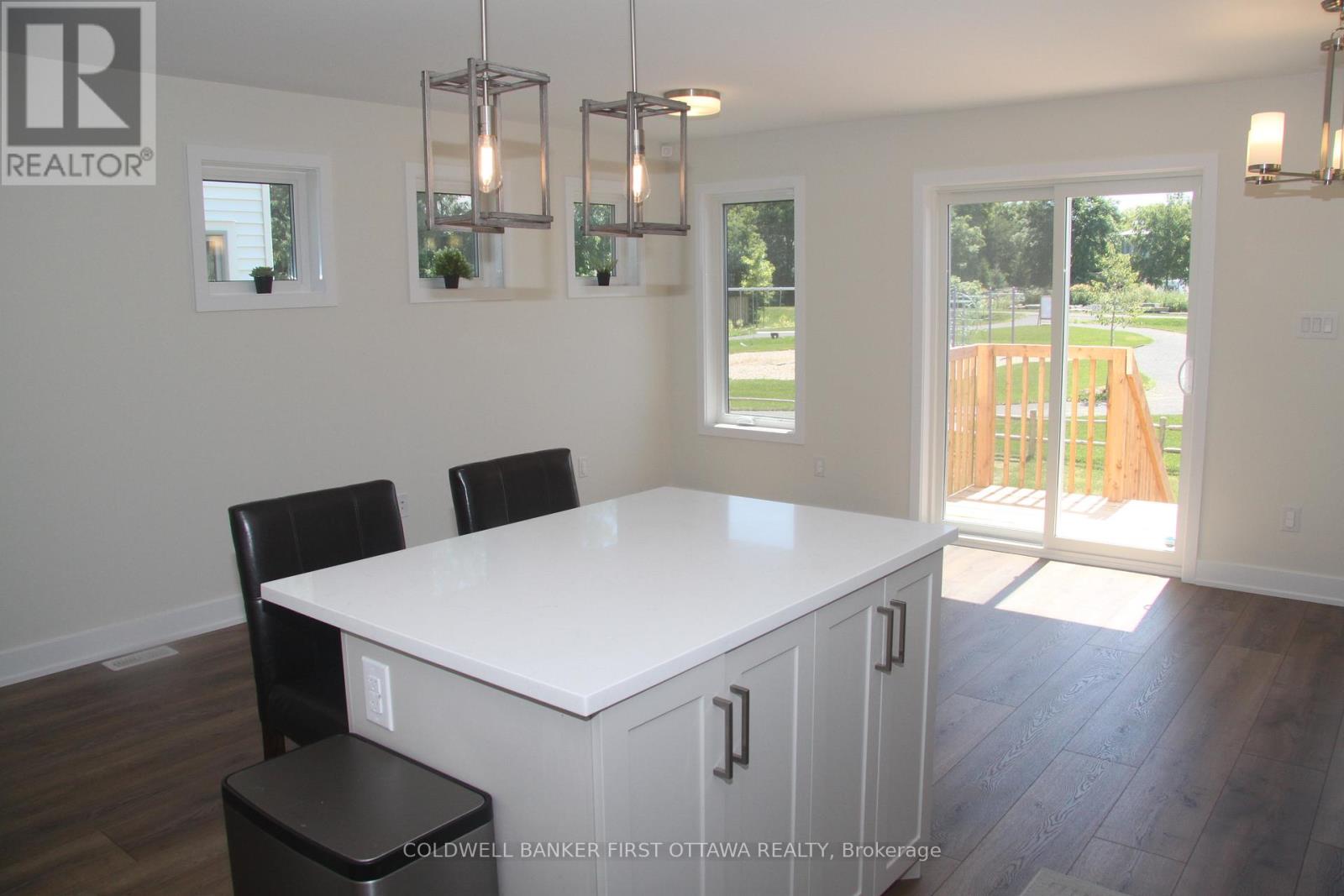 A dining room with a white table and chairs.