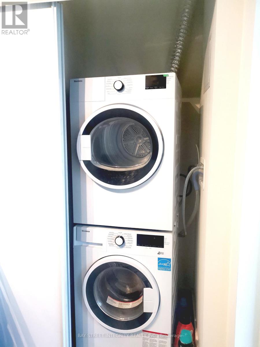 A stacked washer and dryer in a small space.