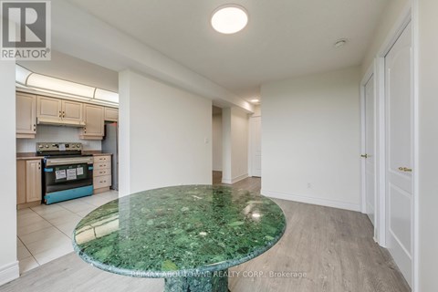A kitchen with a green marble table and white walls.