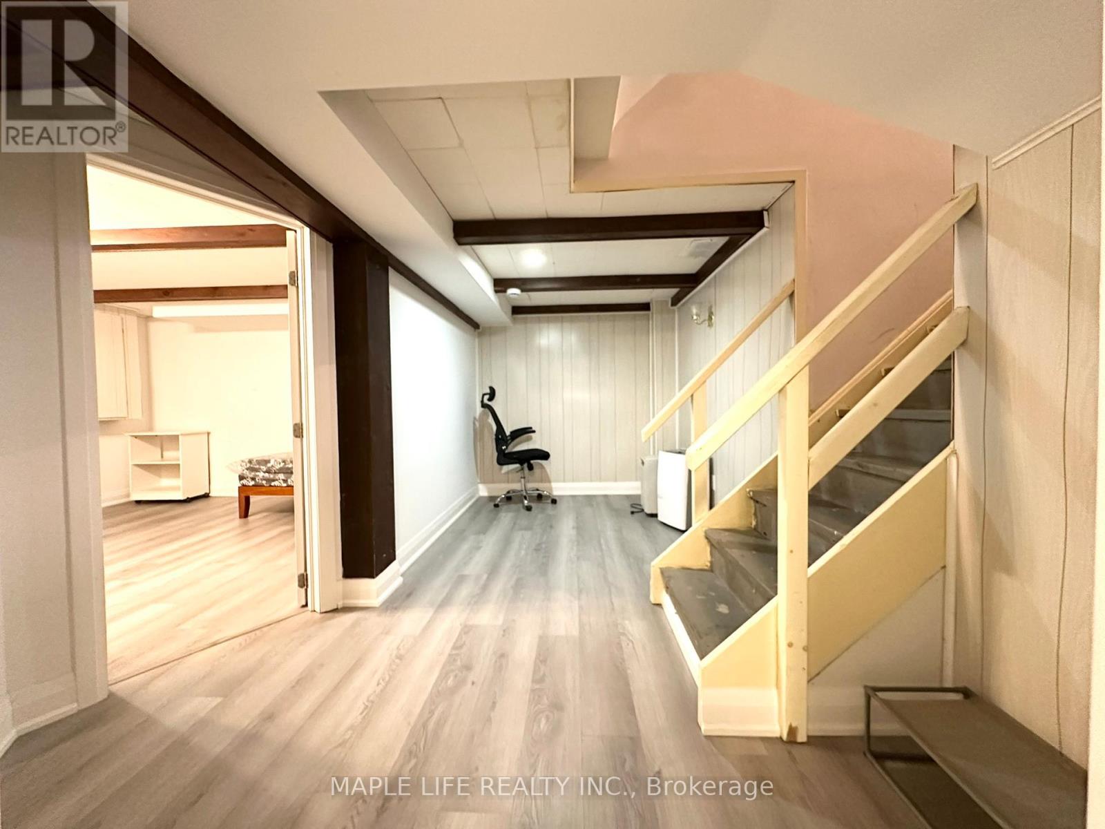 A room with a staircase and a chair.