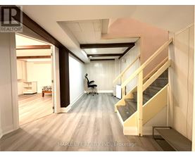 A room with a staircase and a chair.