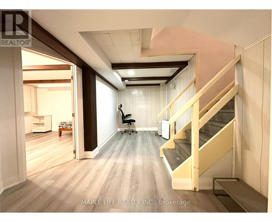 A room with a staircase and a chair.
