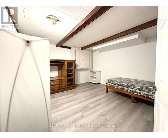 A bedroom with a bed, dresser, and wardrobe.