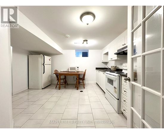 A kitchen with a table and chairs in the middle of it.
