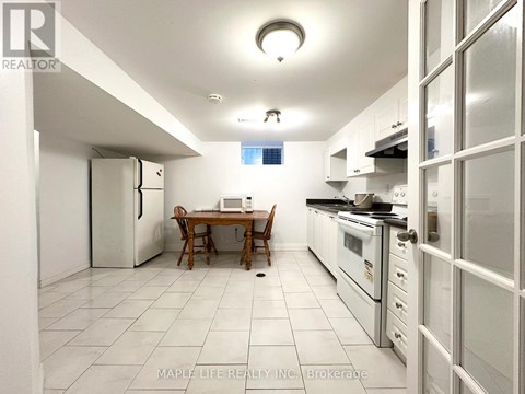 A kitchen with a table and chairs in the middle of it.