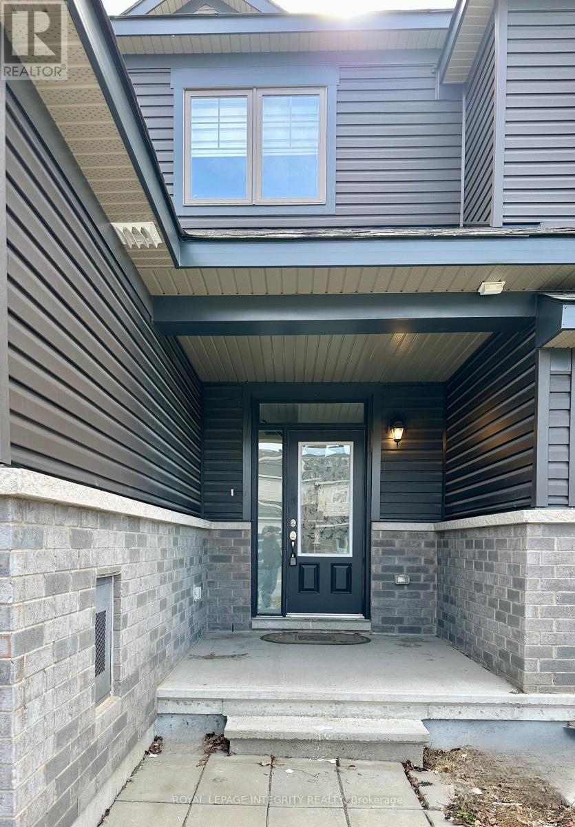 A house entrance with a black door and a glass window.
