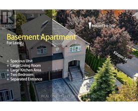 An aerial view of a basement apartment for lease, featuring a spacious unit, large living room, large kitchen area, two bedrooms, and a separated entrance.