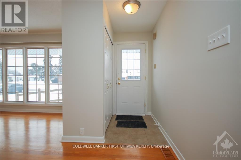 A hallway with a brokerage sign on the wall.