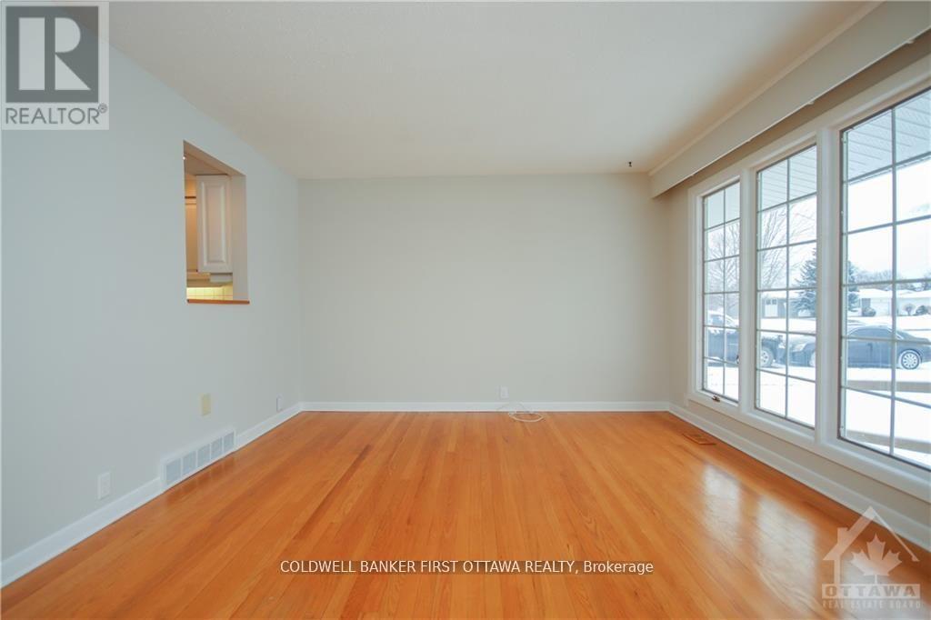 A room with wooden floors and a large window.