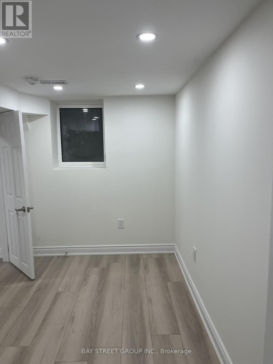 A room with a white door and a window with a white wall.