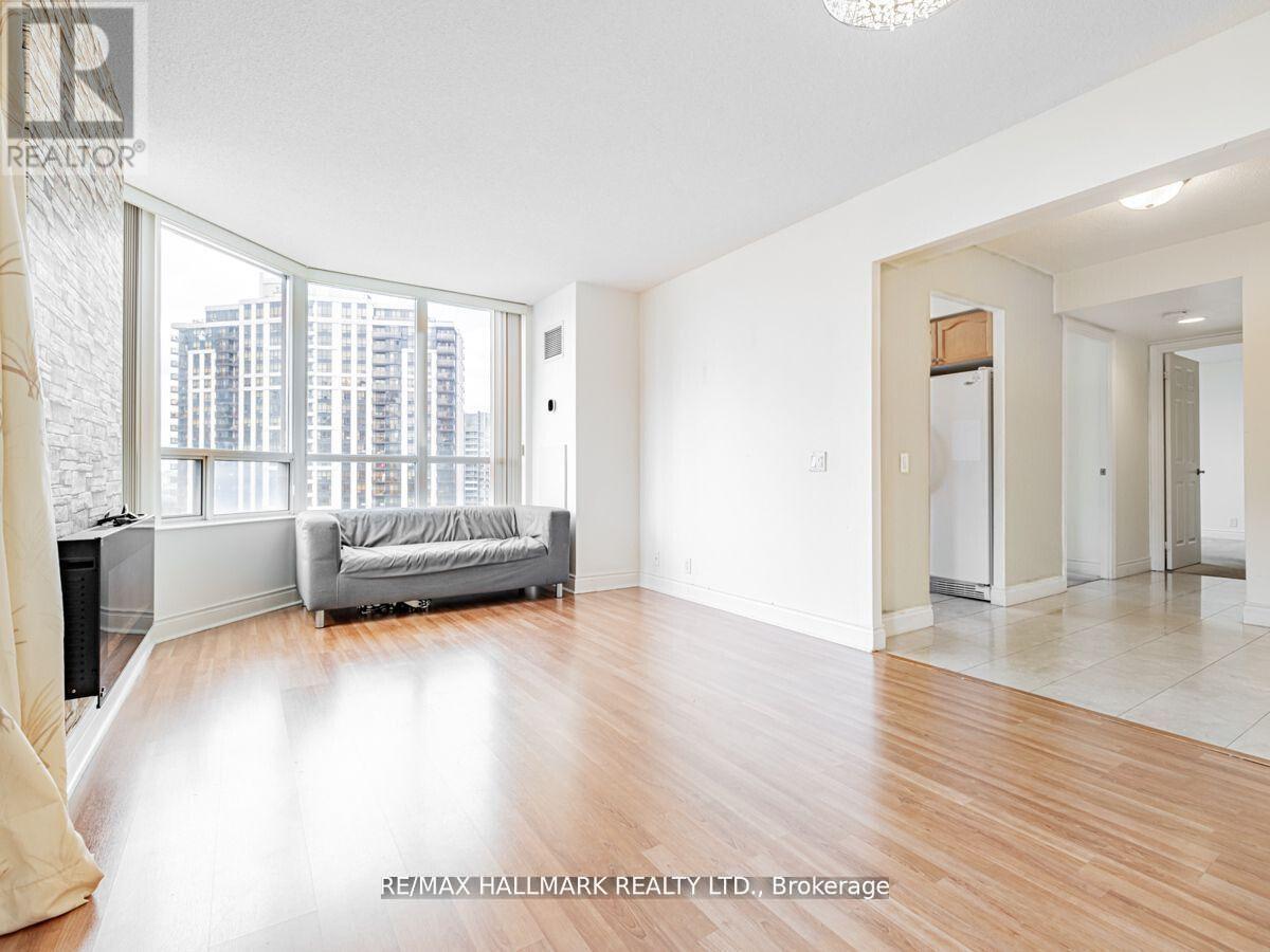 A spacious living room with a couch and a large window.