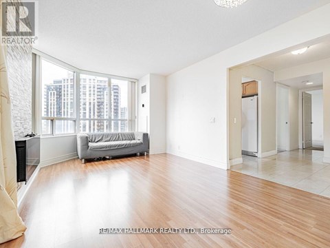 A spacious living room with a couch and a large window.