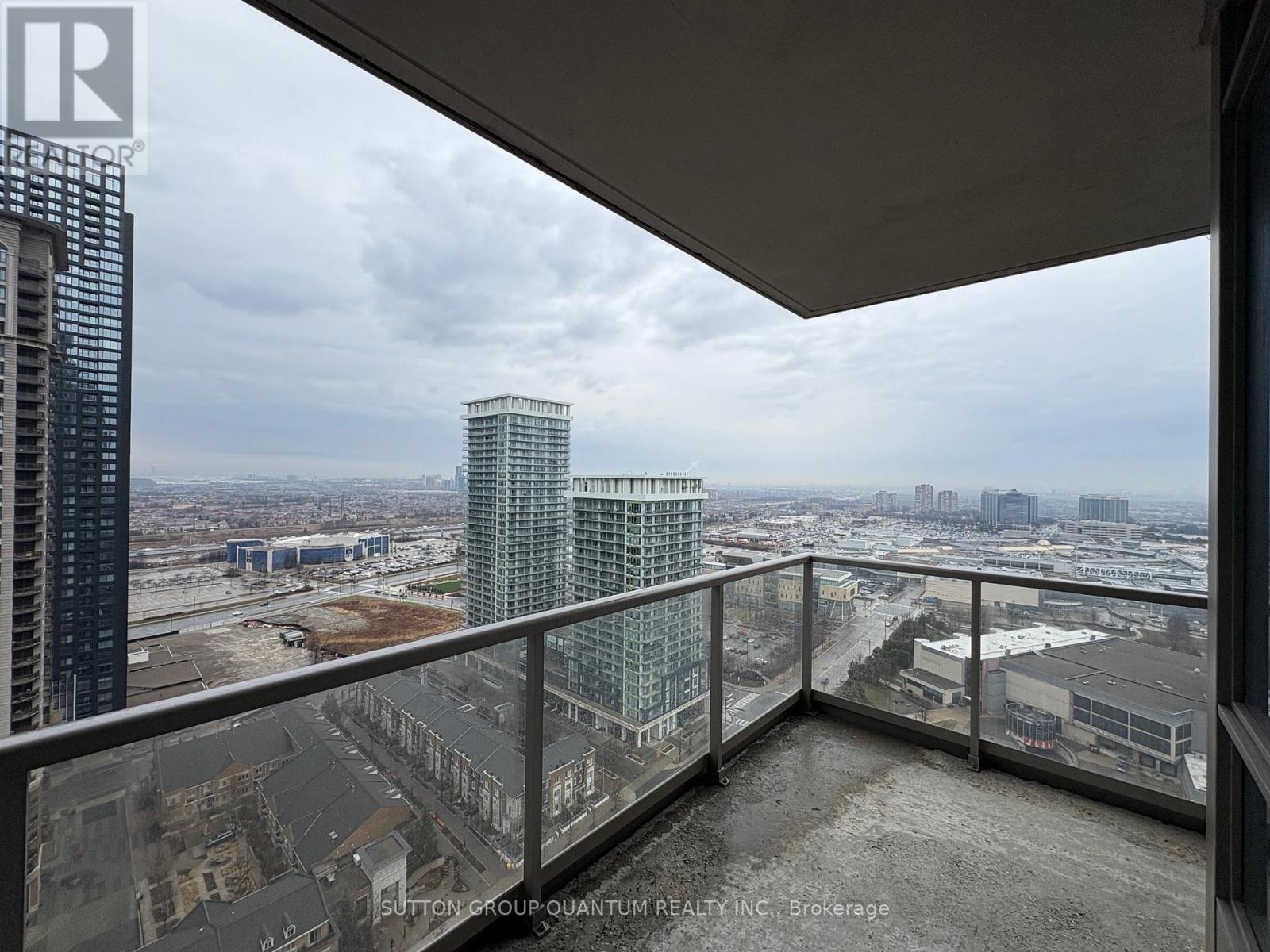 A balcony overlooks a cityscape with buildings and construction.