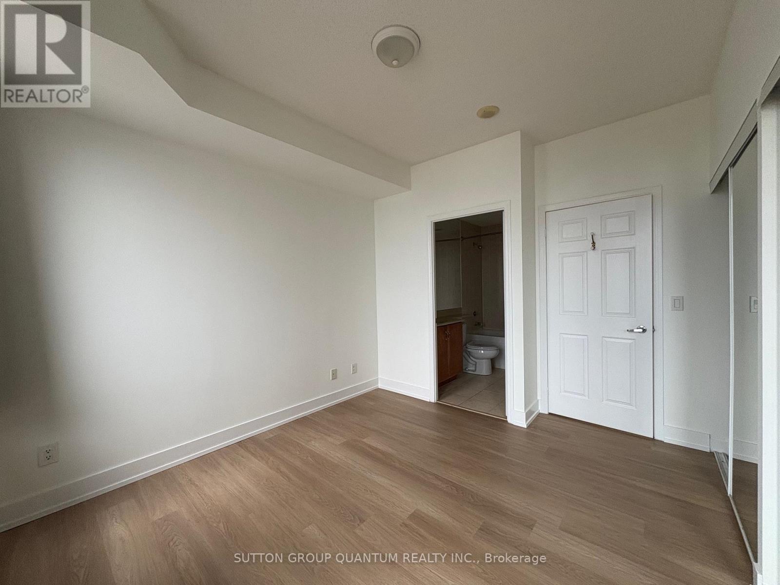 A room with a white door and a window.