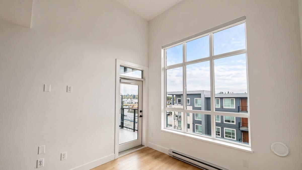A room with a large window overlooking a cityscape.