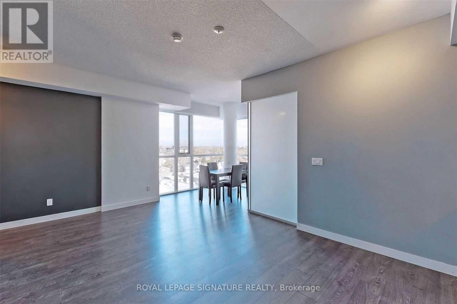 A spacious room with a dining table and chairs is on the market with Royal LePage Signature Realty in Brokerage.