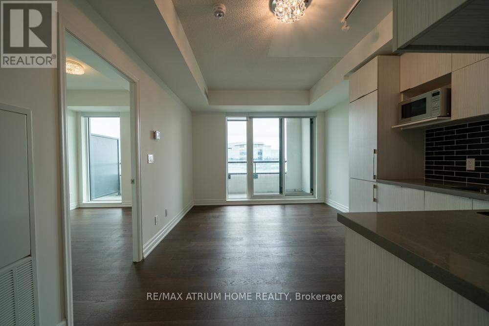 A spacious room with a view of the city through the windows.