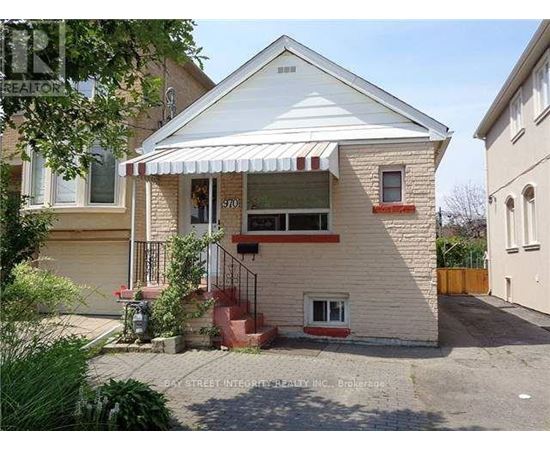 A house with a white roof and a red awning is for sale.