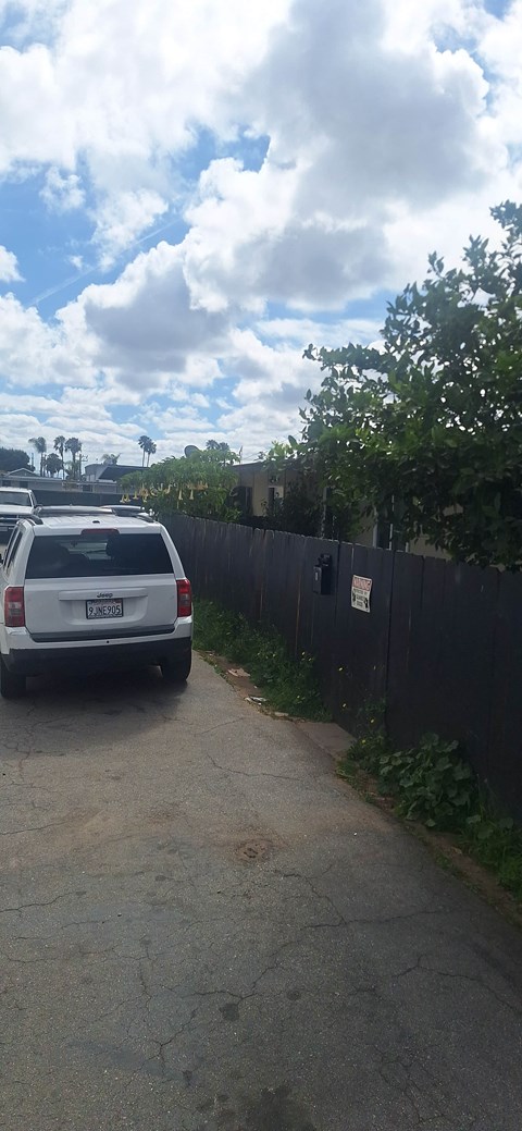 A white van is parked on a driveway.