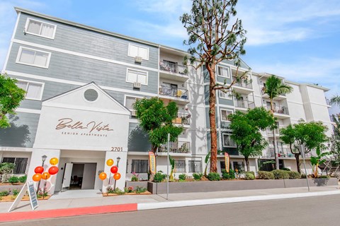A multi-story residential building with the name "Bella Vista" on the front.