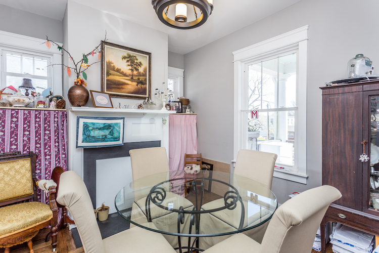 A living room with a glass table and chairs.