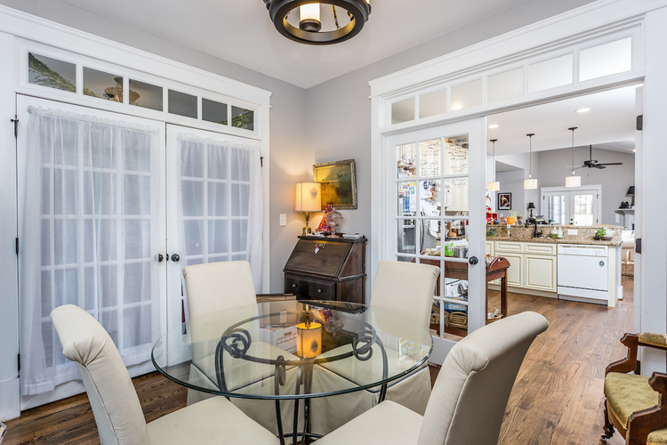 A dining room with a glass table and chairs.