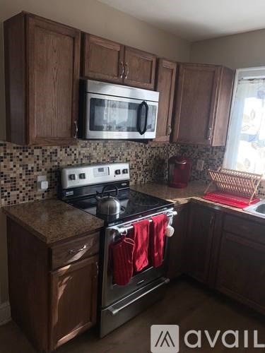 A kitchen with a stove top oven and microwave above it.