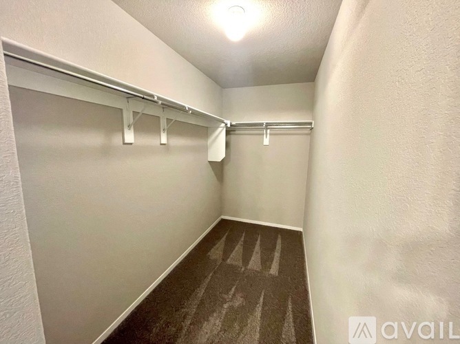 A small, empty room with a carpeted floor and white walls.