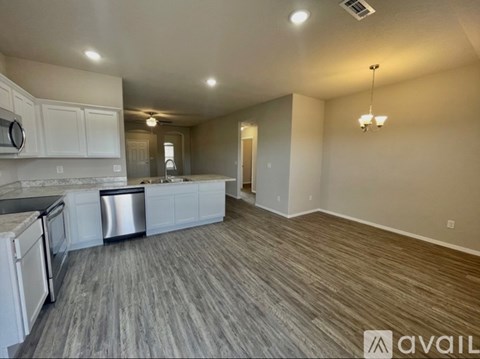 A kitchen with white cabinets and a dishwasher is available for rent.
